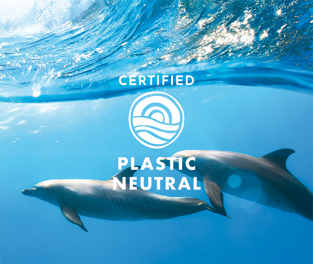 Two dolphins swimming in clear blue water with a 'Certified Plastic Neutral' logo overlay.