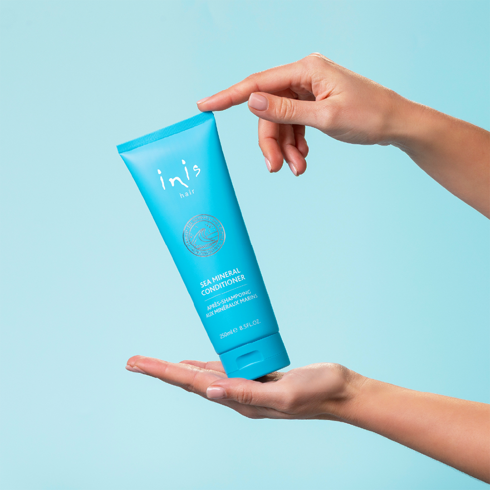 Blue tube of inis hair sea mineral conditioner on a white background