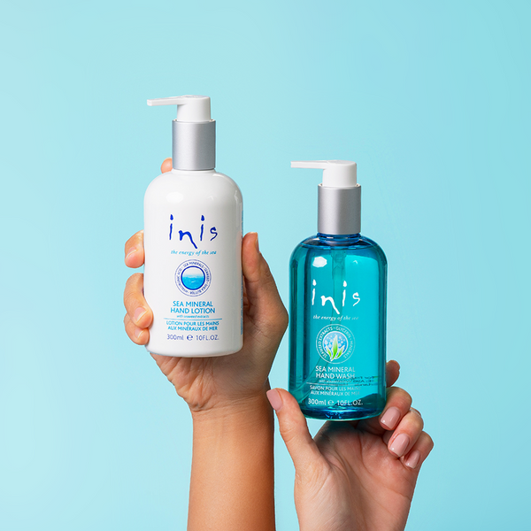 Two bottles of 'inis' hand lotion and hand wash with a light blue background